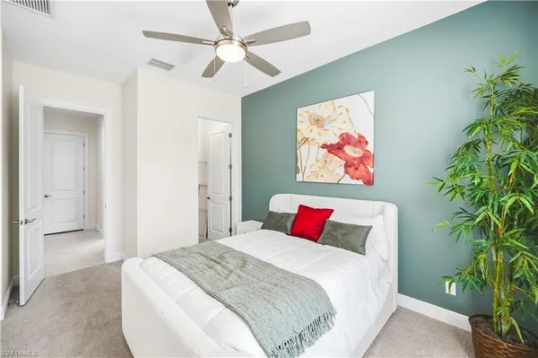 a bedroom with a large bed and a chandelier