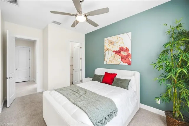 a bedroom with a large bed and a chandelier