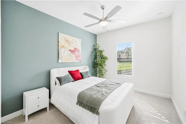 a bathroom with a granite countertop sink a toilet and a mirror