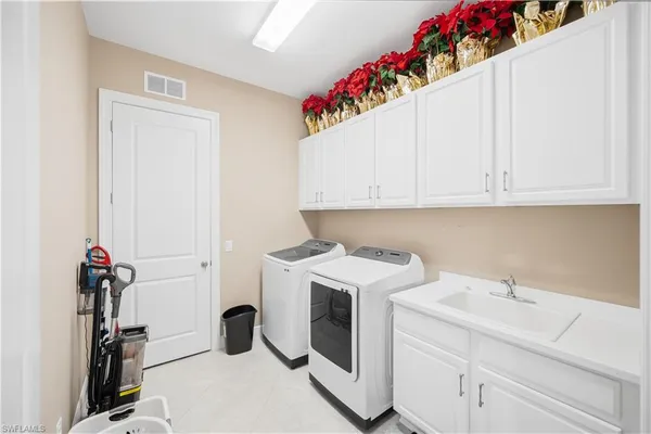 a front view of a house with a garden and palm trees