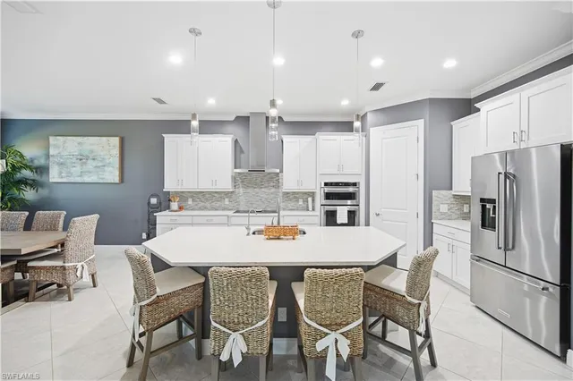 a living room with furniture a flat screen tv and a potted plant
