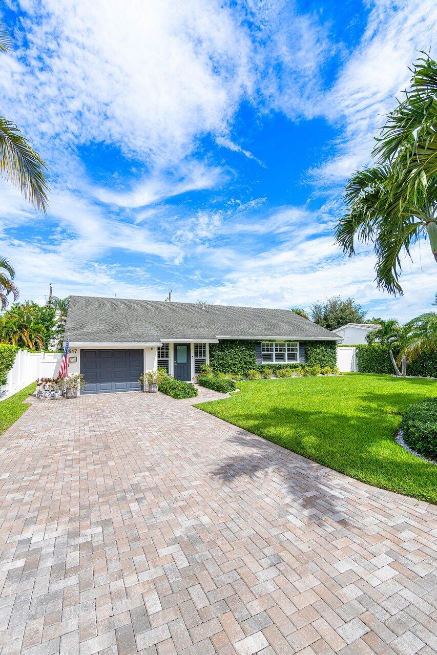 517 Aylesbury Road Delray Beach, FL 33444 - Photo 55 of 56 a front view of house with yard and green space