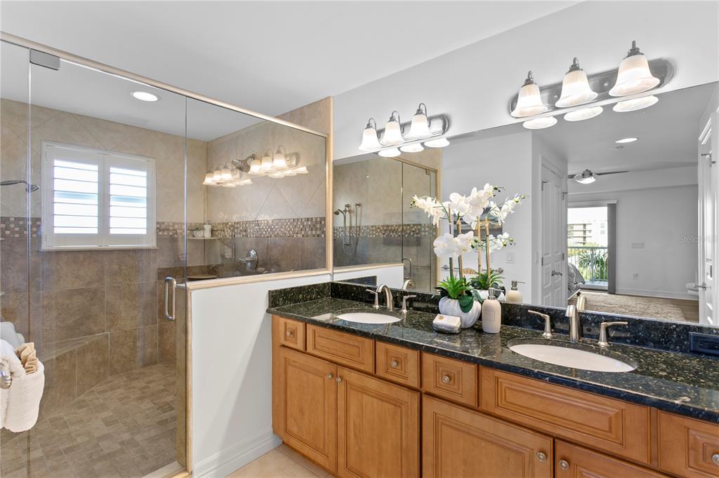 19730 Gulf Boulevard, Unit 400 Indian Rocks Beach, FL 33785 - Photo 67 of 90 a bathroom with a sink mirror and a shower