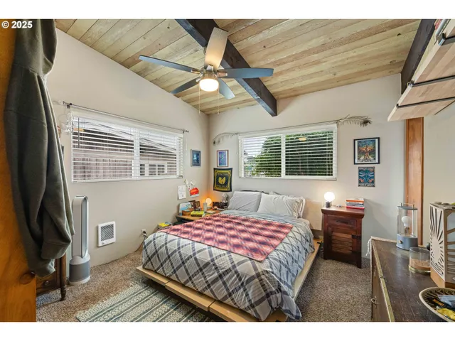 a bedroom with a bed dresser and a window