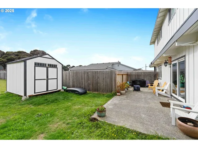 a view of a backyard with furniture and a tub