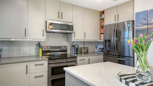 a bathroom with a glass shower door and a sink