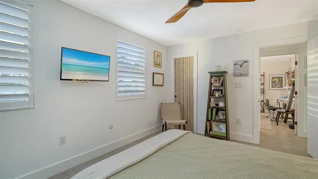 a living room with patio furniture and a potted plant