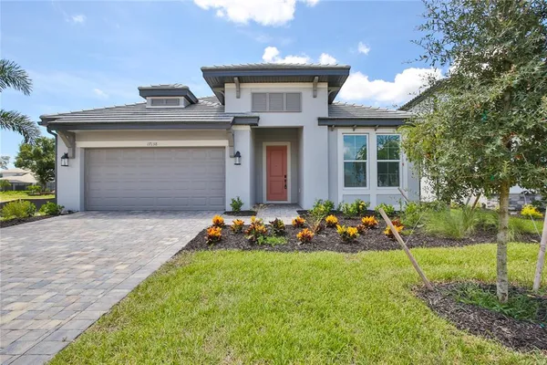 a front view of a house with a yard and outdoor seating
