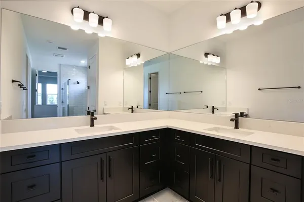 a bathroom with a glass shower door and a mirror