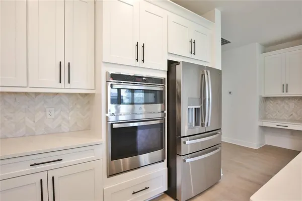 a kitchen with stainless steel appliances and refrigerator