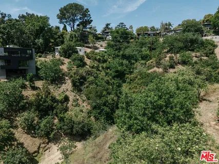 an aerial view of a house with yard