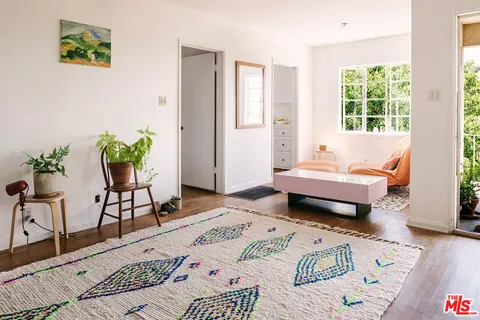 a bedroom with two beds and a large window