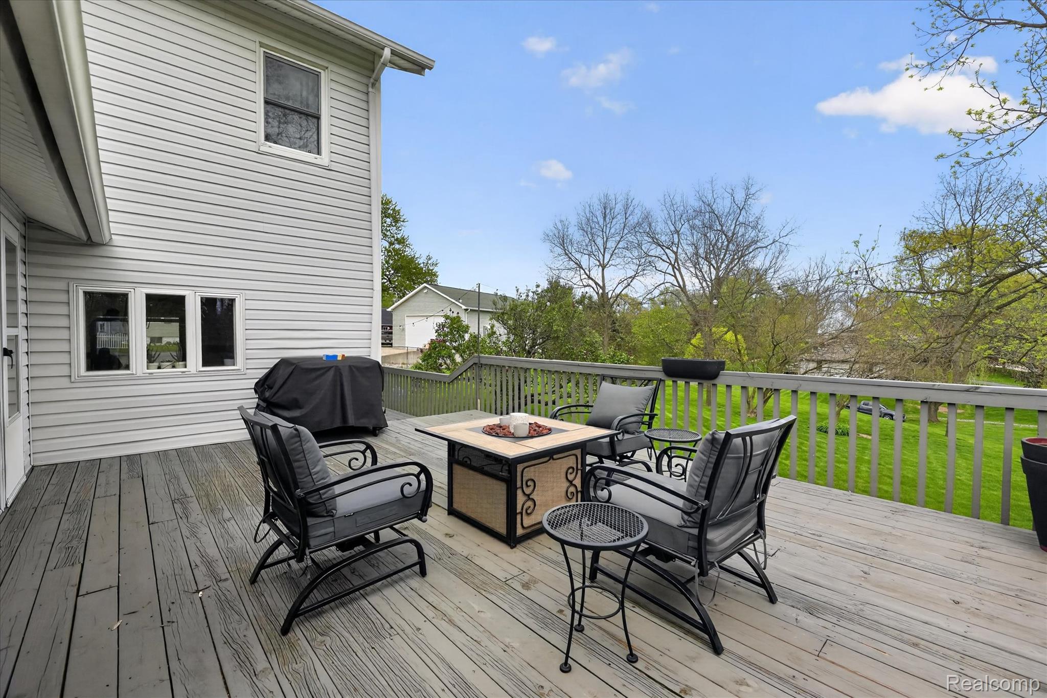 12409 Fenton Road Fenton, MI 48430 - Photo 32 of 61 Wooden deck featuring area for grilling and a fire pit