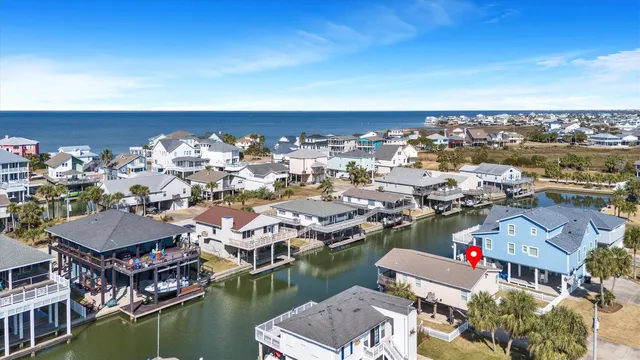 an aerial view of a house with a ocean view