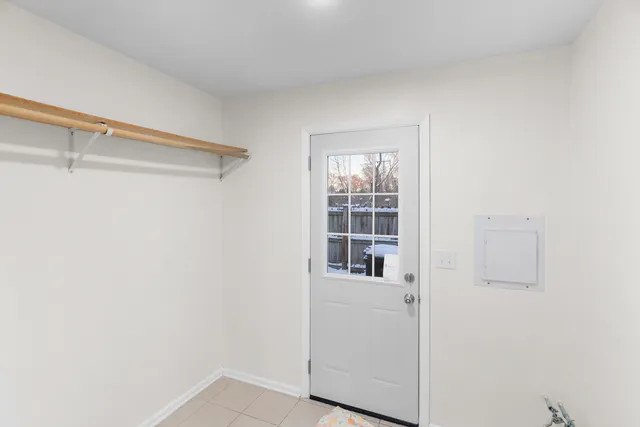 a view of walk in closet with empty racks