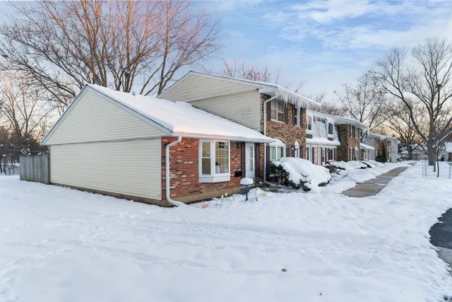 a view of a house with a snow in the yard