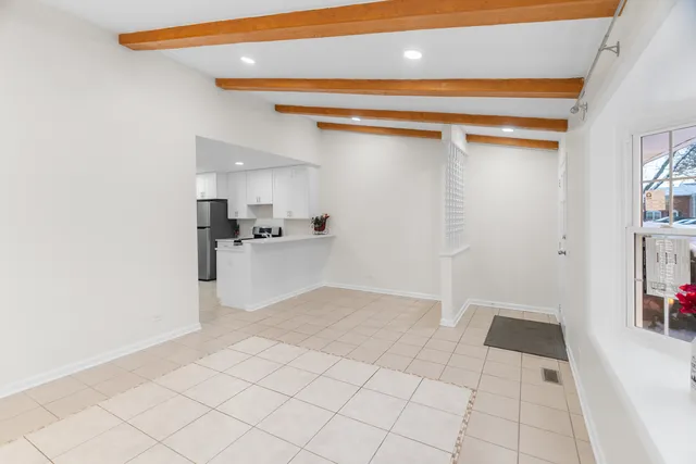 a view of kitchen with refrigerator and window