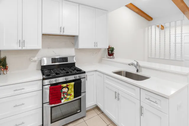 a kitchen with stainless steel appliances granite countertop a sink a stove and cabinets