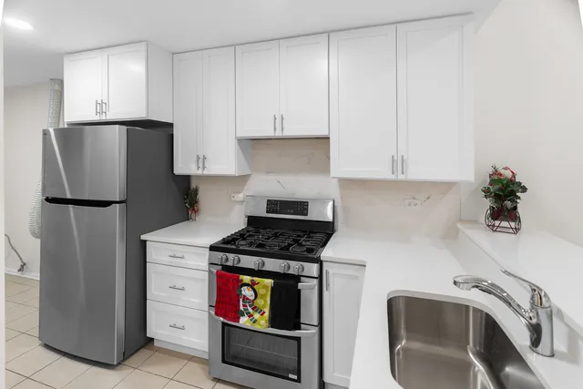 a kitchen with stainless steel appliances granite countertop a refrigerator sink and stove