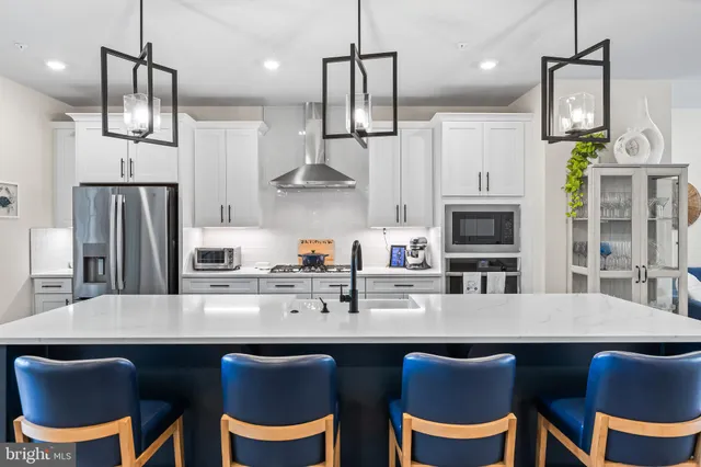 a bathroom with a double vanity sink a mirror and a toilet