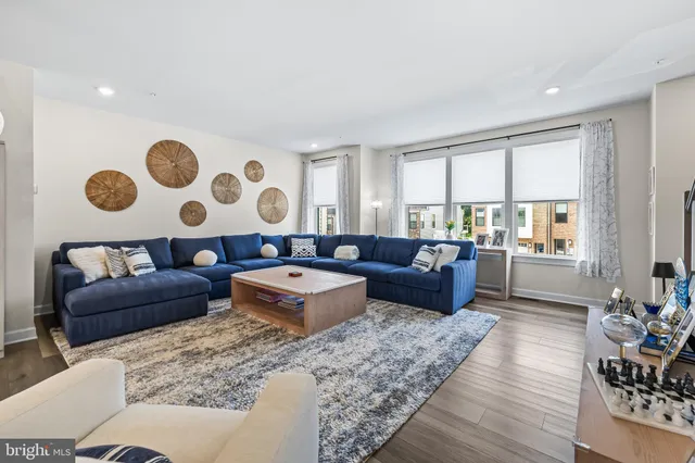 a living room with furniture kitchen view and a table