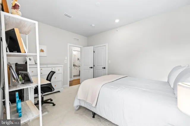 a bathroom with a granite countertop toilet sink and mirror