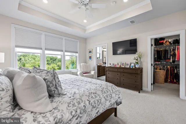 a spacious bedroom with a bed and a chandelier