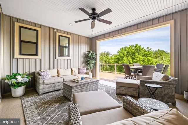 a view of a balcony with furniture and wooden floor