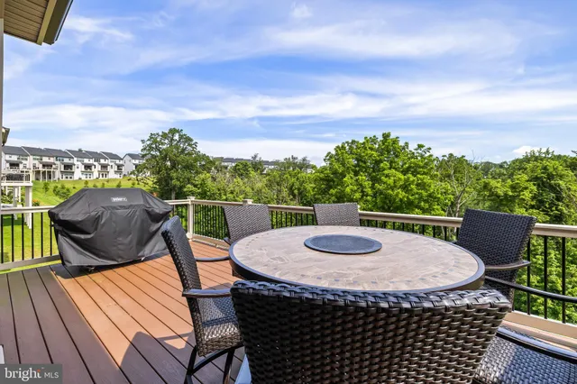 a front view of a residential apartment building with a yard table and chairs