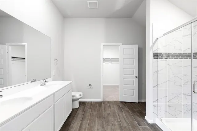 an empty room with chandelier fan and windows