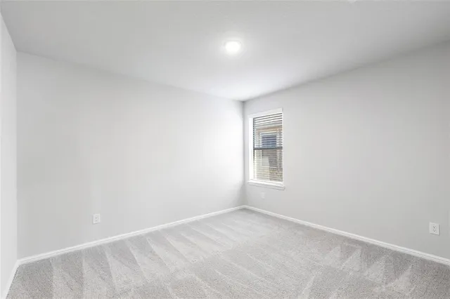 a bathroom with a bathtub shower sink vanity mirror and toilet