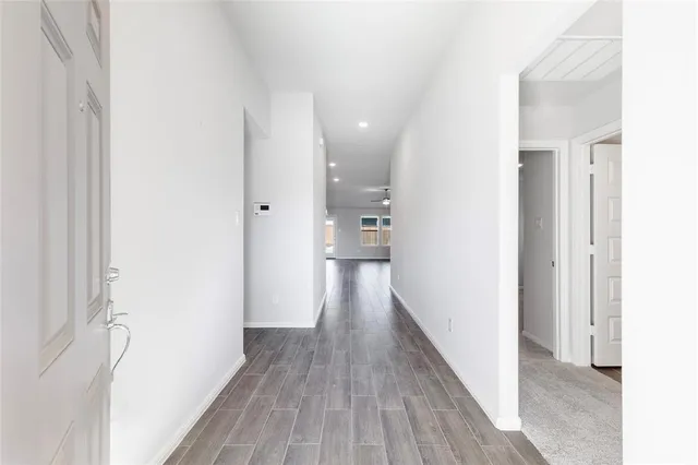 a view of a hallway with wooden floor