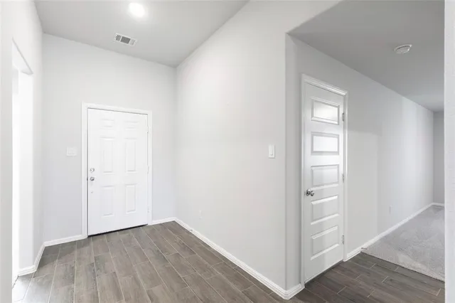 a view of hallway with wooden floor