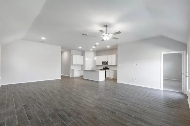 a kitchen with a refrigerator and a stove top oven