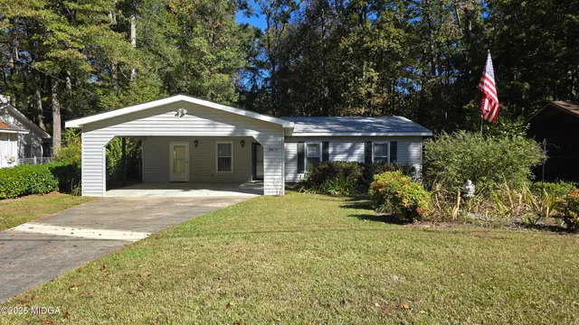 a front view of a house with a garden