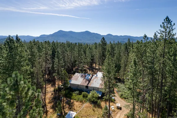 an aerial view of a house with mountain view