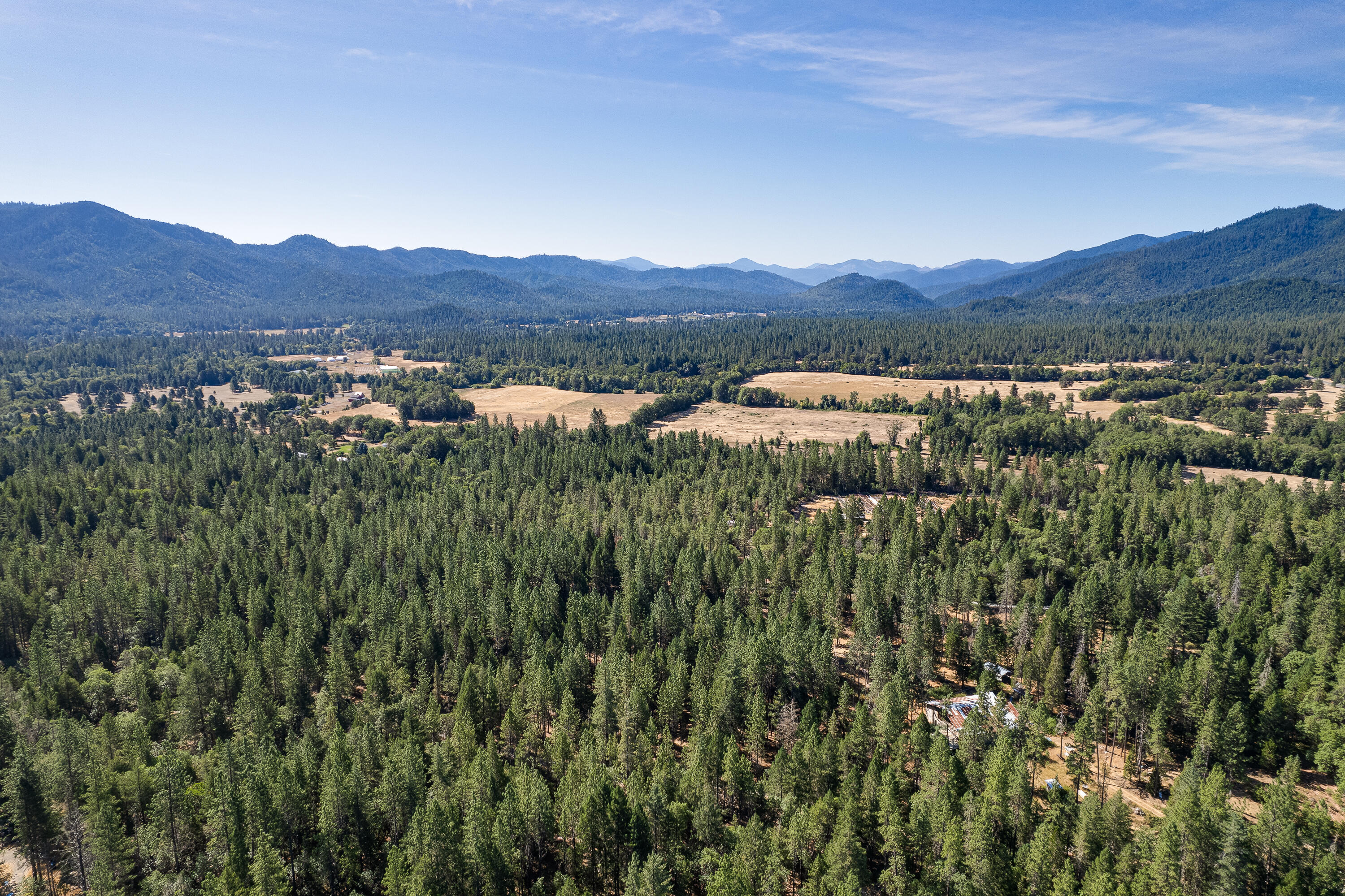 9184 West Evans Creek Road Rogue River, OR 97537 - Photo 11 of 29 a view of a lush green field with mountains in the background