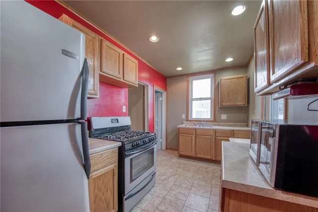 a kitchen with granite countertop a sink stove and cabinets