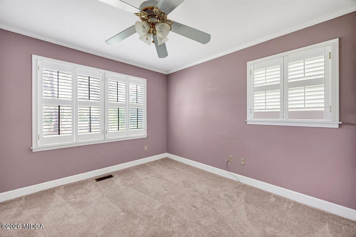 335 Hamrick Road Macon, GA 31220 - Photo 24 of 41 an empty room with a chandelier fan and windows