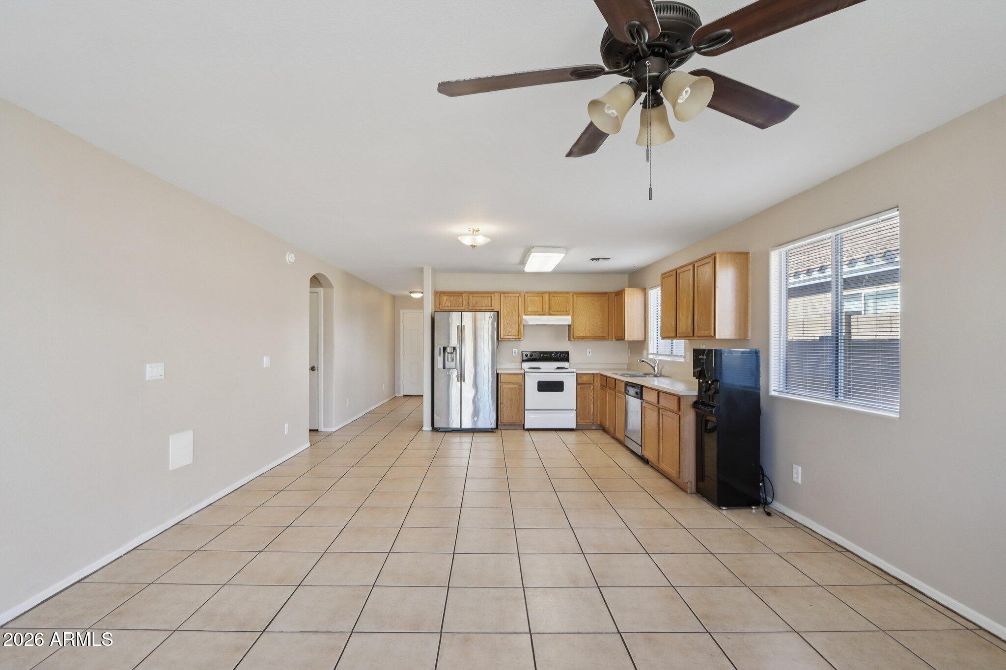 3326 West Shumway Farm Road Phoenix, AZ 85041 - Photo 11 of 30 a view of a kitchen with a sink and a stove top oven