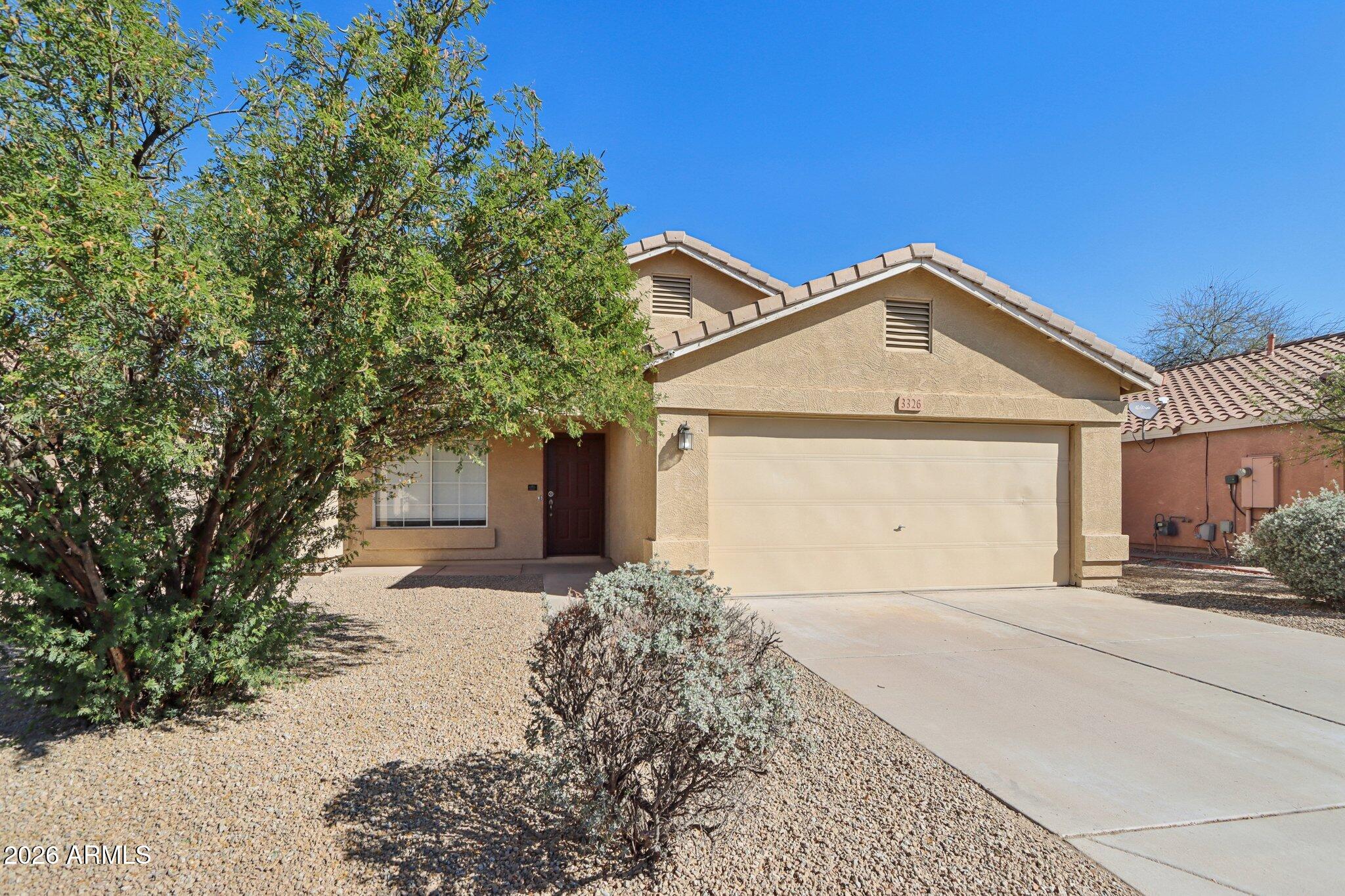 3326 West Shumway Farm Road Phoenix, AZ 85041 - Photo 2 of 30 a front view of a house with a yard and garage
