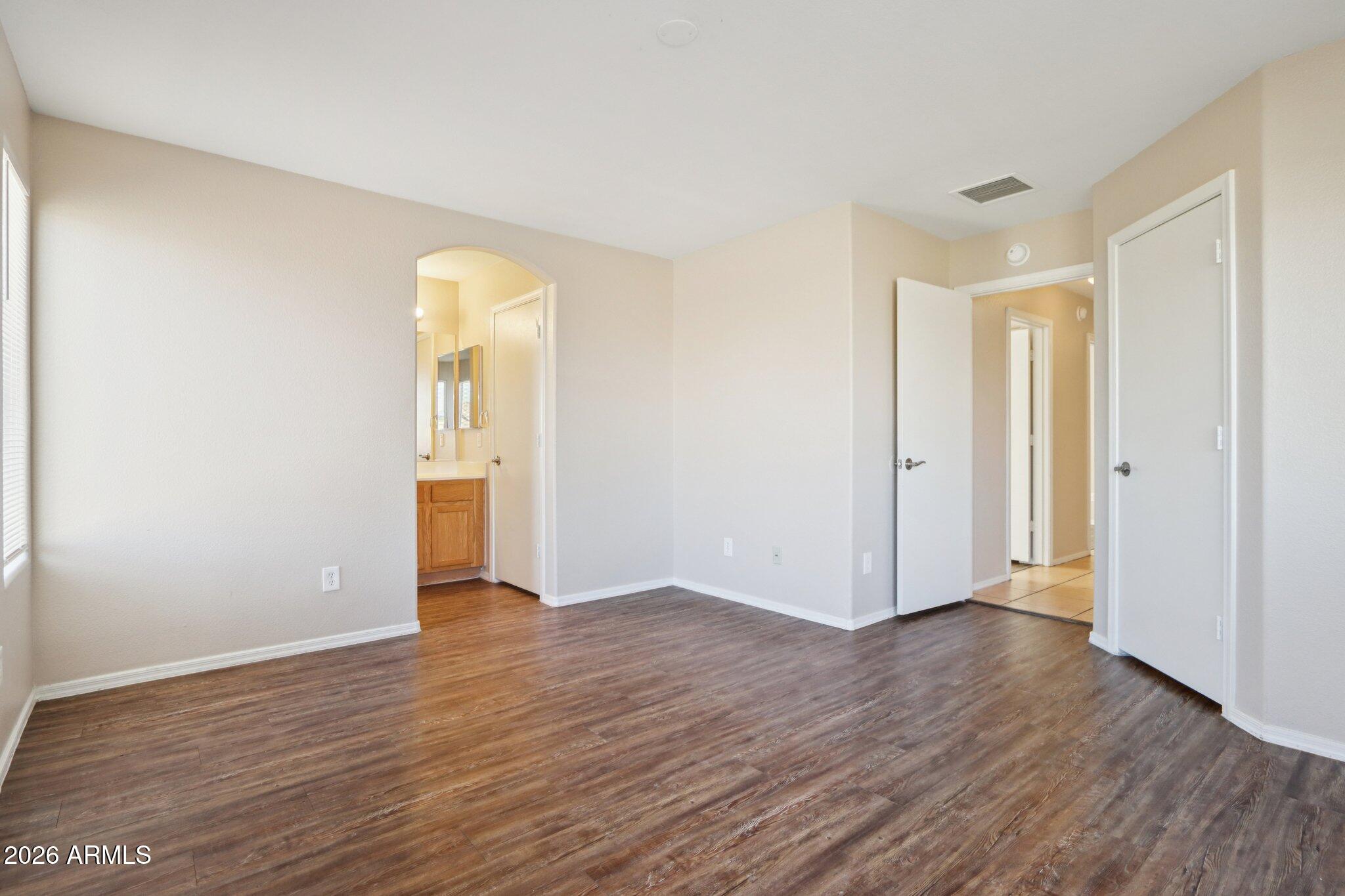 3326 West Shumway Farm Road Phoenix, AZ 85041 - Photo 24 of 30 a view of an empty room with wooden floor and closet