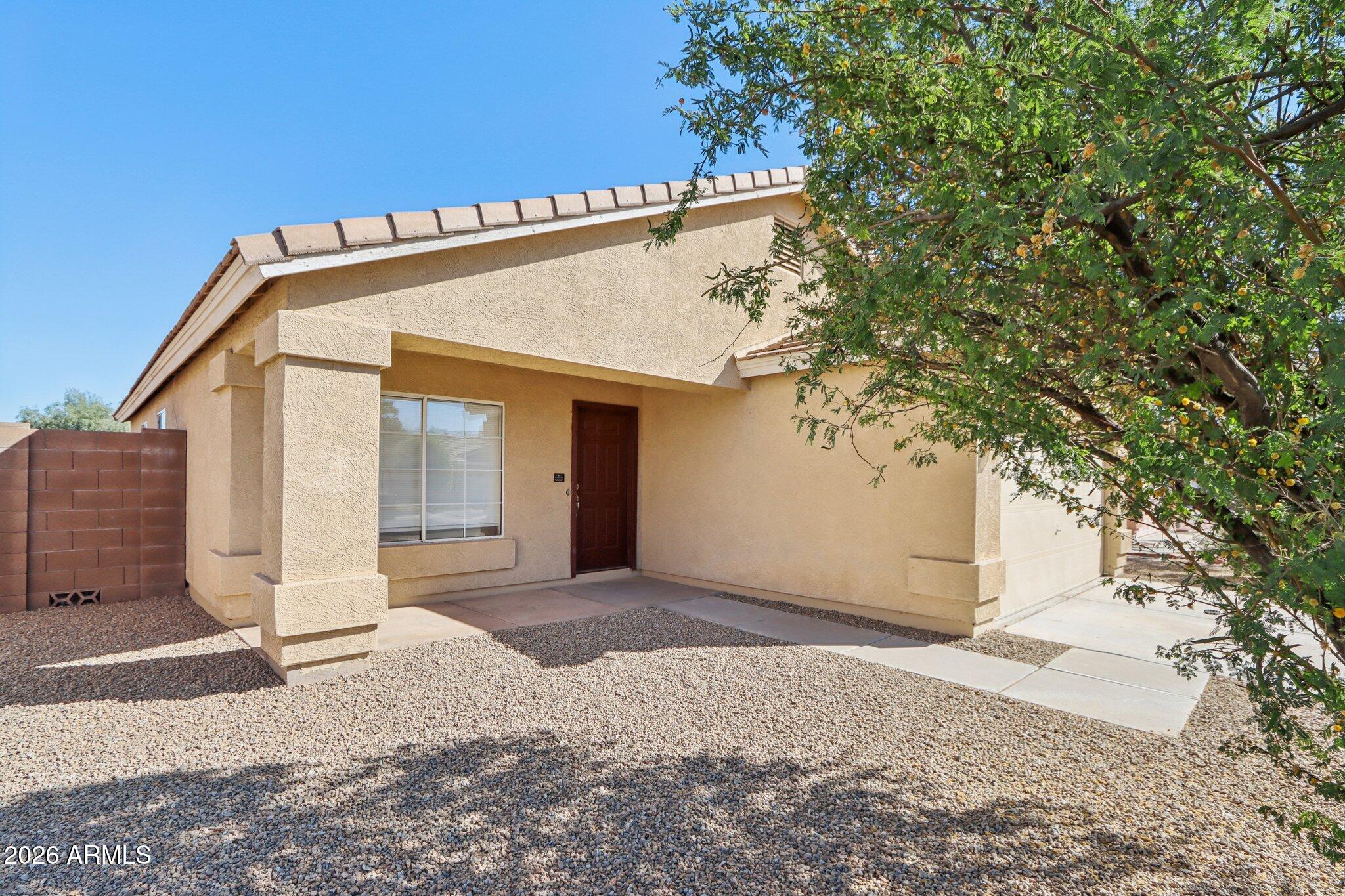 3326 West Shumway Farm Road Phoenix, AZ 85041 - Photo 4 of 30 a front view of a house with a yard and garage