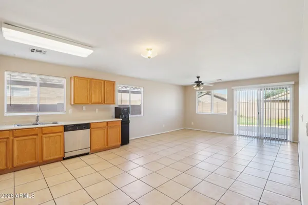 a large kitchen with a sink and cabinets