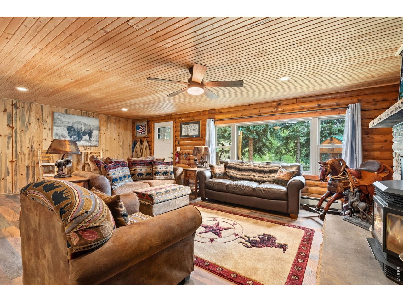 12743 Rist Canyon Road Bellvue, CO 80512 - Photo 11 of 49 a living room with furniture and a large window