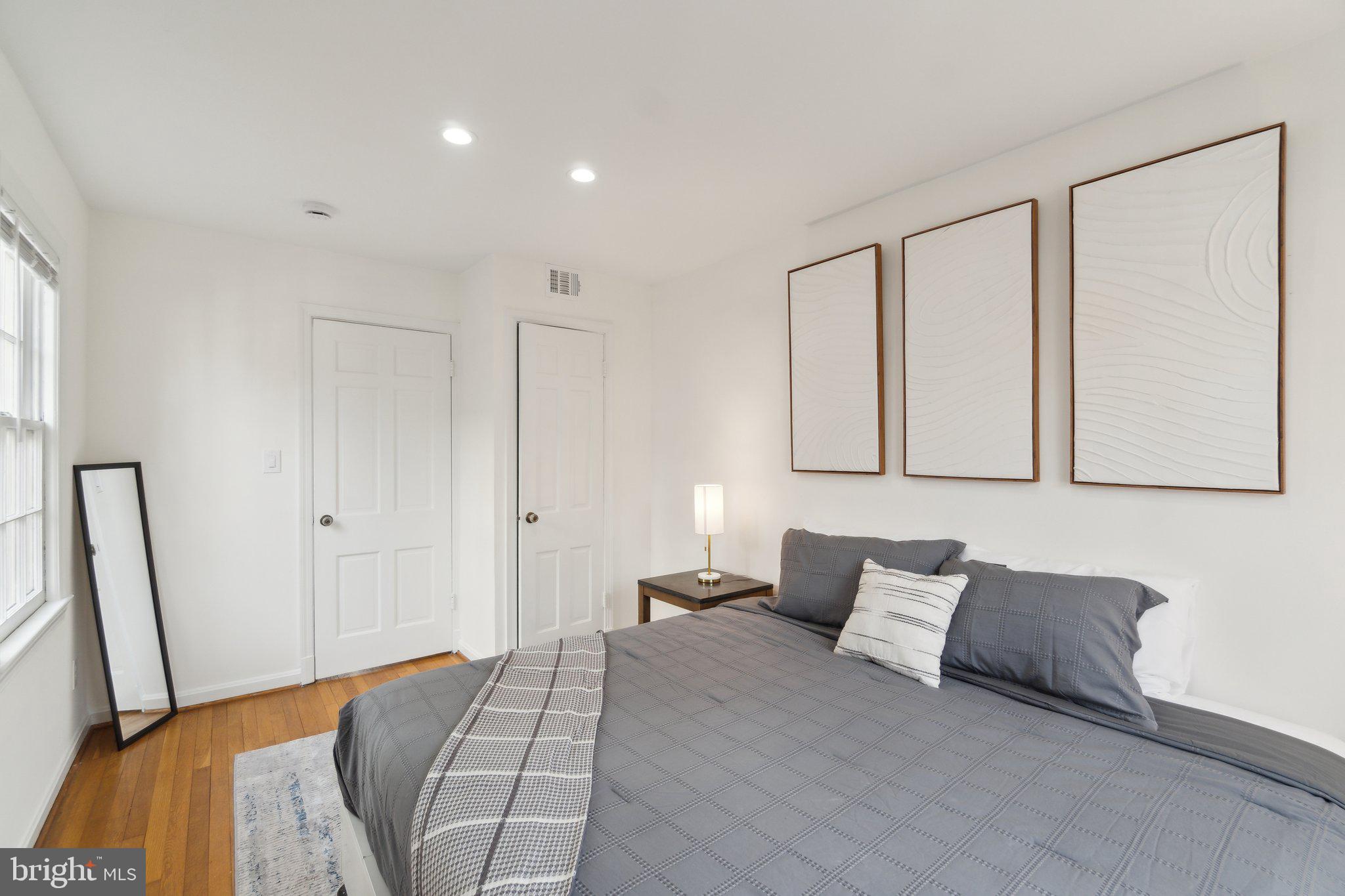 19 Snows Court Northwest Washington, DC 20037 - Photo 11 of 21 a bed room with a bed and a couch