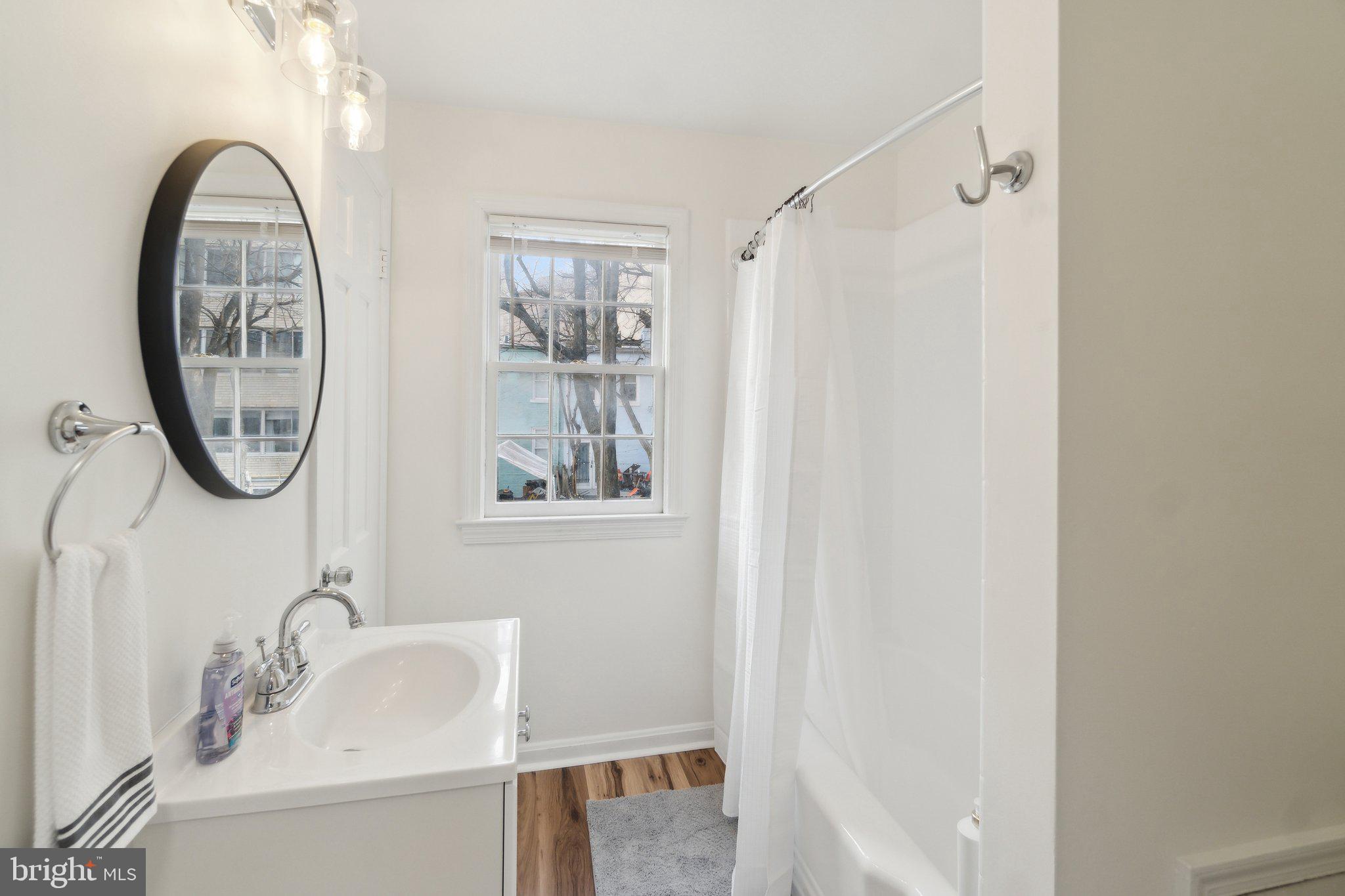 19 Snows Court Northwest Washington, DC 20037 - Photo 12 of 21 a bathroom with a sink and a mirror