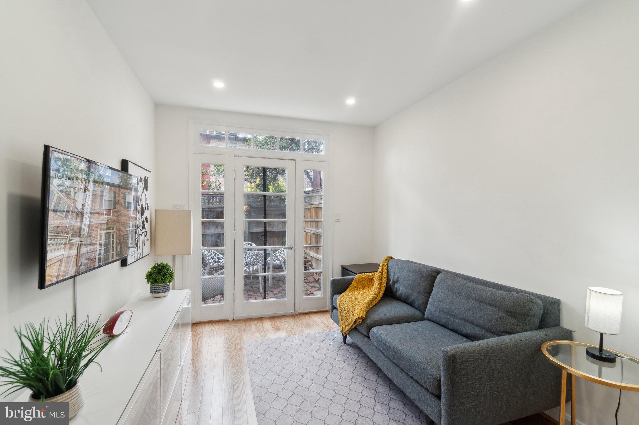 19 Snows Court Northwest Washington, DC 20037 - Photo 2 of 21 a living room with furniture and a potted plant