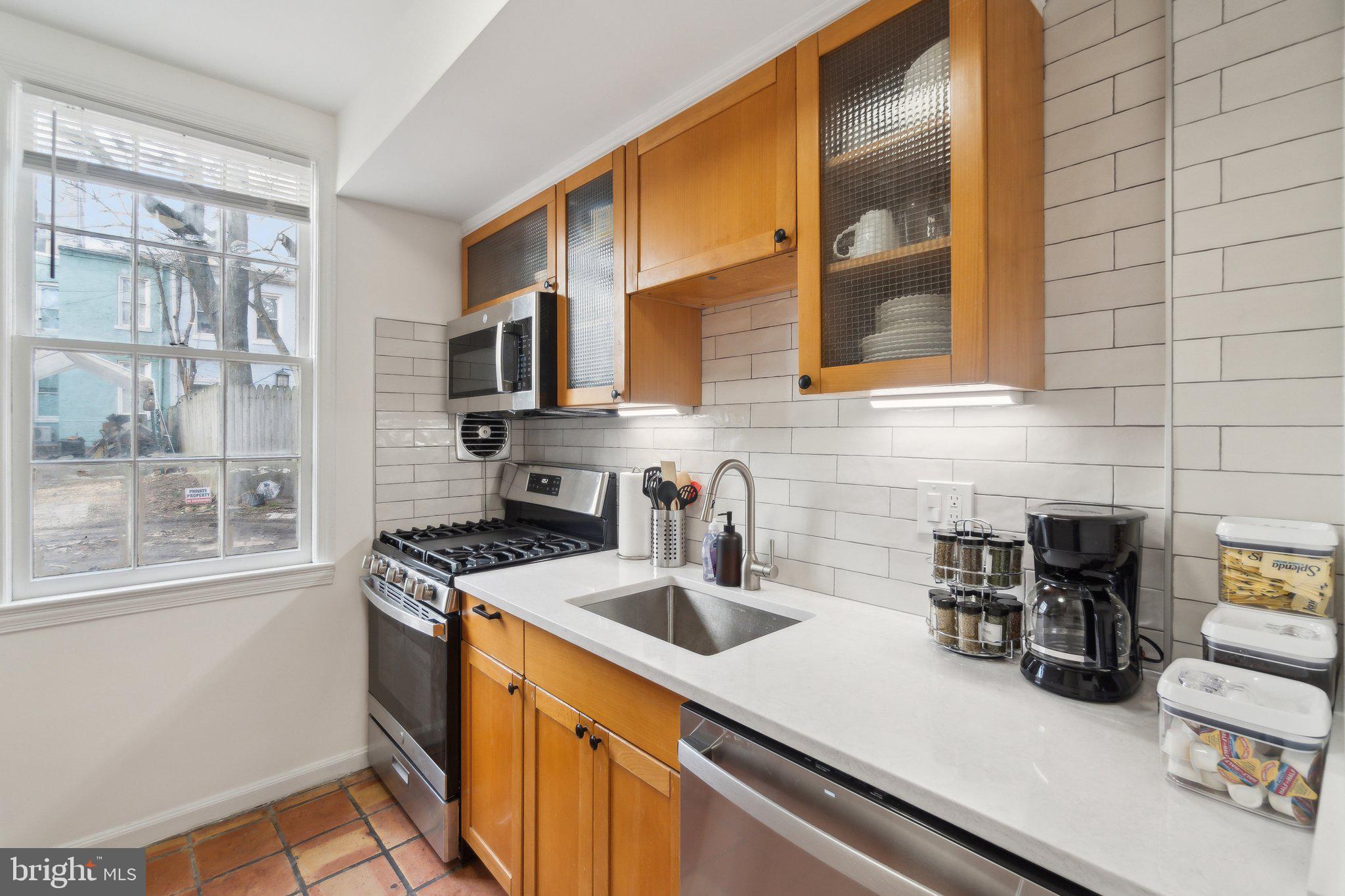 19 Snows Court Northwest Washington, DC 20037 - Photo 7 of 21 a kitchen with stainless steel appliances a sink a stove and a refrigerator