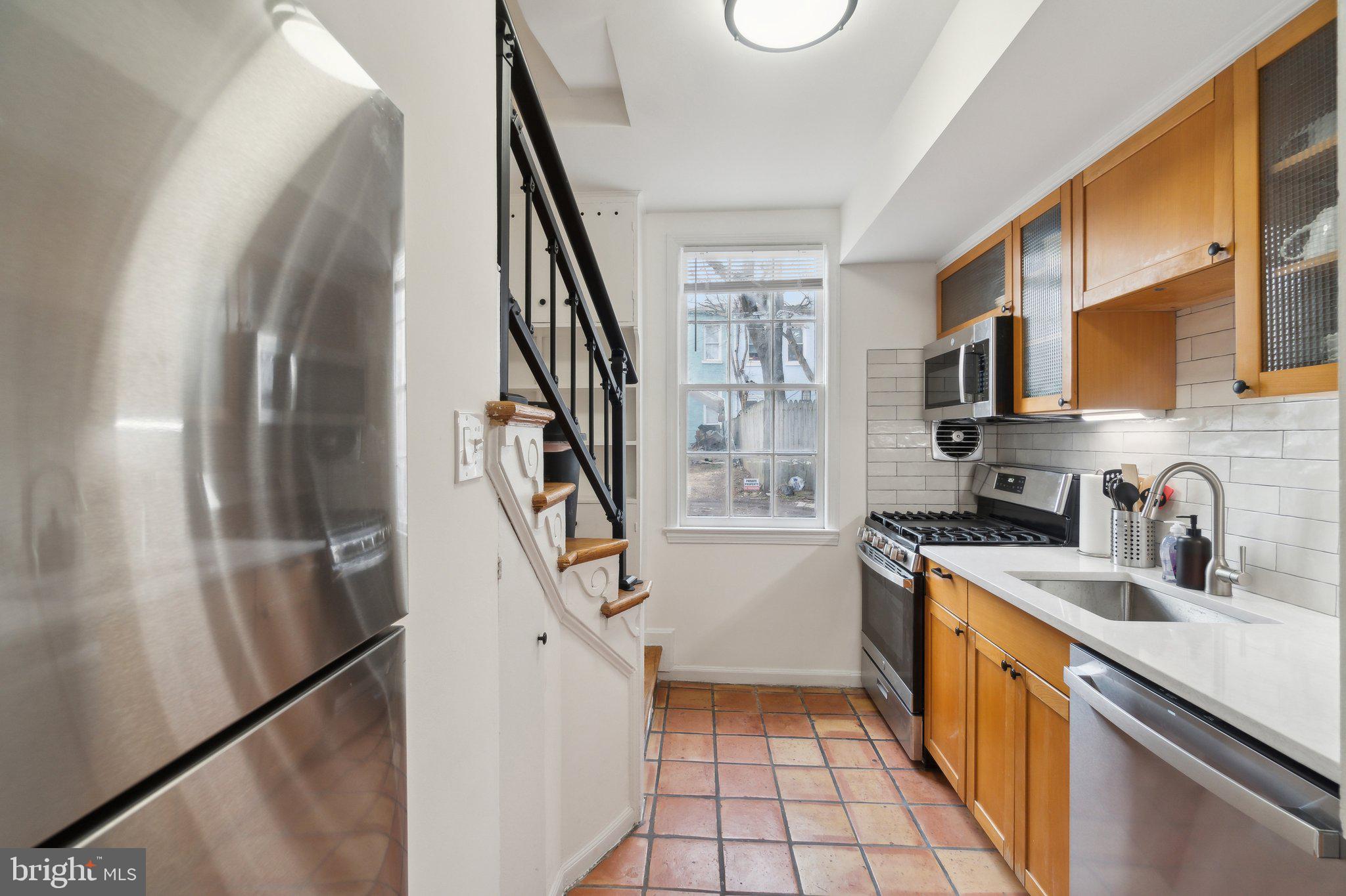 19 Snows Court Northwest Washington, DC 20037 - Photo 8 of 21 a kitchen with granite countertop a sink a stove top oven and cabinetry